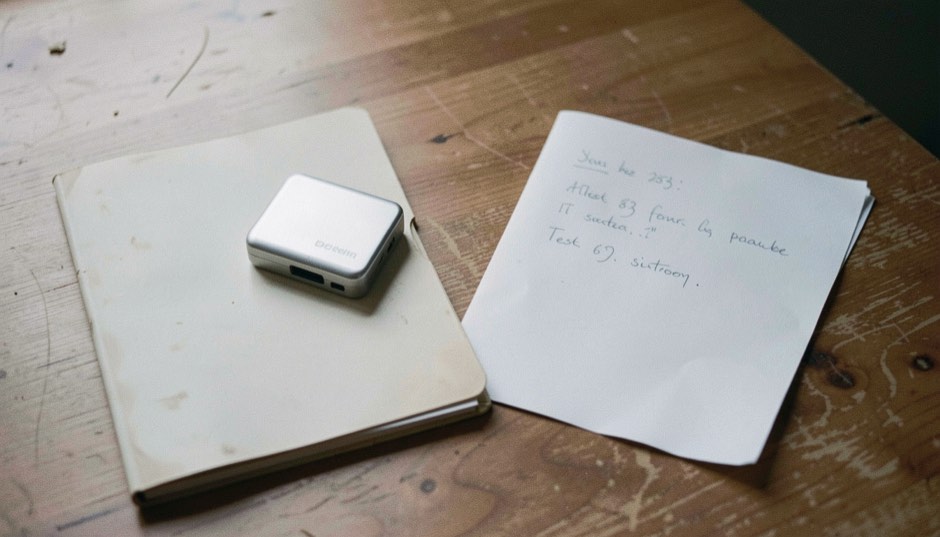 Documentary photograph of a small external drive, a restored blank folder and a handwritten test sheet turned away, no legible writing, clear morning light. Distinct home journal 5 composition for this editorial entry.
